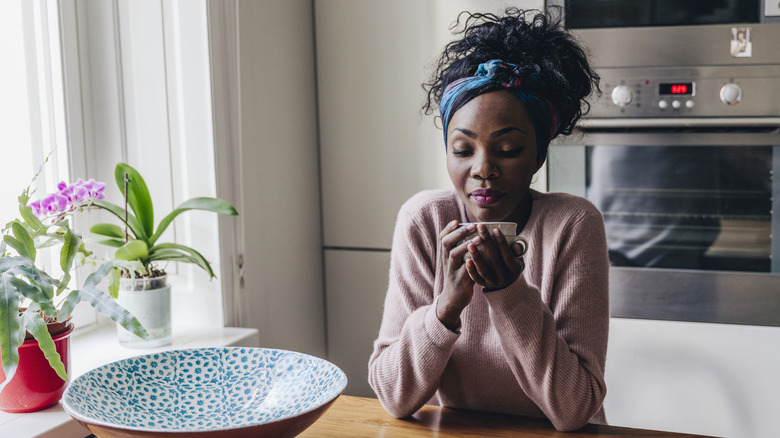 Woman drinking coffee and savoring alone time