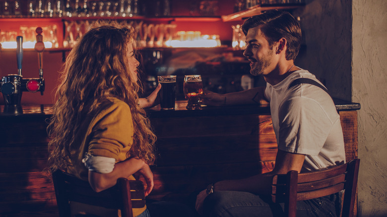 Couple flirting at a bar