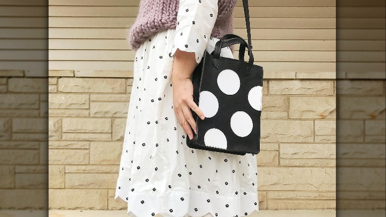Woman in polka dot dress with polka dot bag