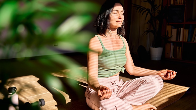 woman meditates outdoors
