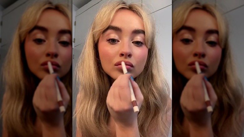 Sabrina applying lip liner