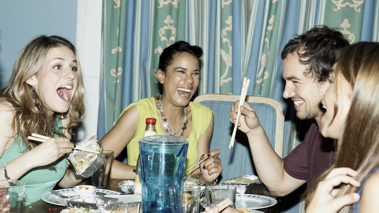 Friends laughing at dinner