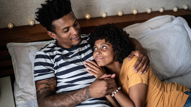 Couple talking in bed