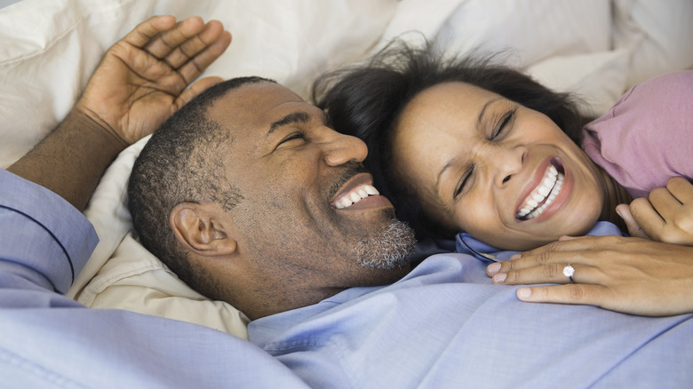 Couple smiling in bed