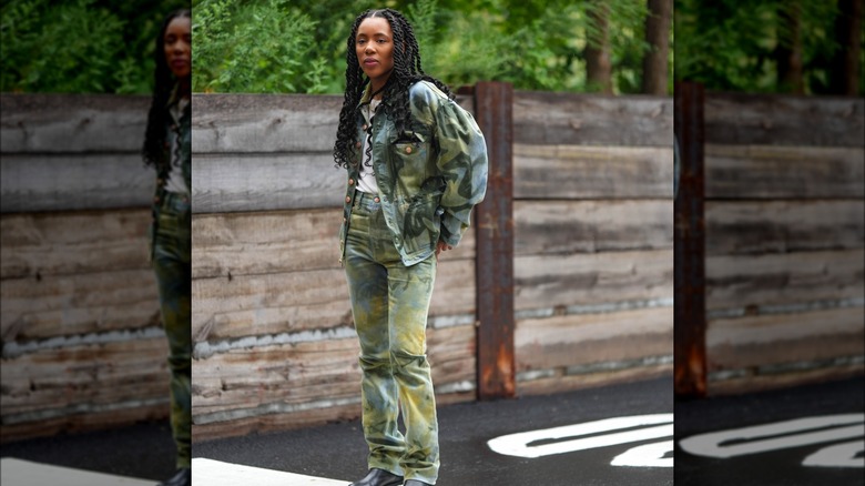 A woman in a camo outfit 