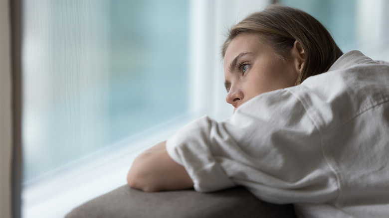 woman staring out window