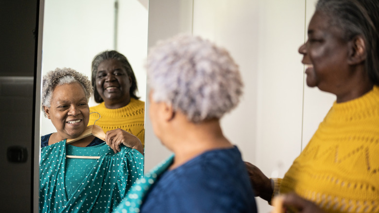 Women smiling and wearing colorful outfits