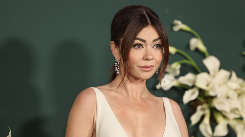 Sarah Hyland on the red carpet in a white gown