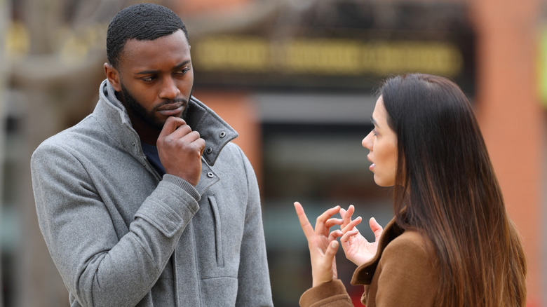 woman and man talking on the street