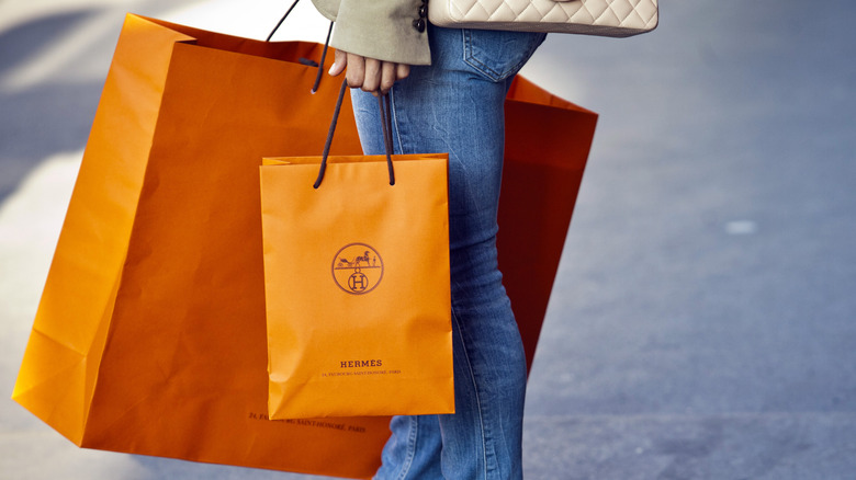 woman holding designer shopping bags