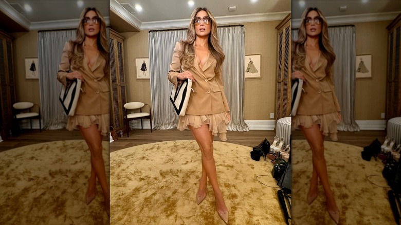 Jennifer Lopez in a tan blazer and mini skirt posing