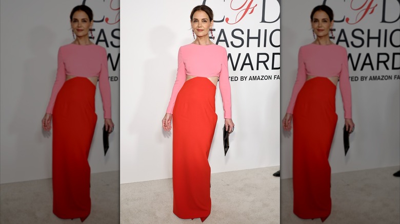 Katie Holmes in a red and pink dress at an event