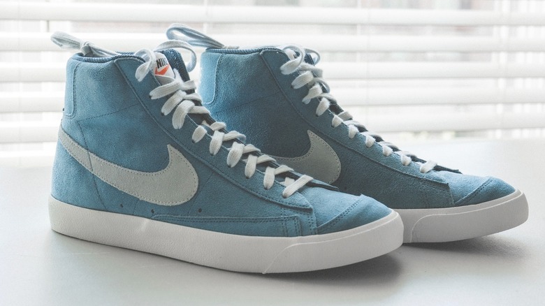 blue Nike suede sneakers in white light