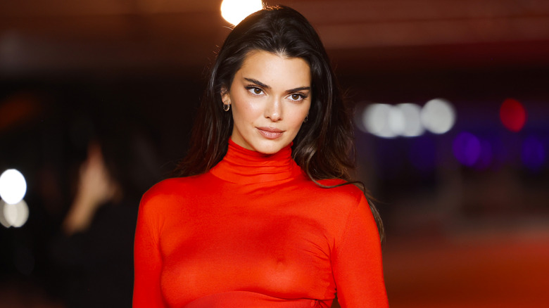 Kendall Jenner looking to the side while posing at a red carpet event