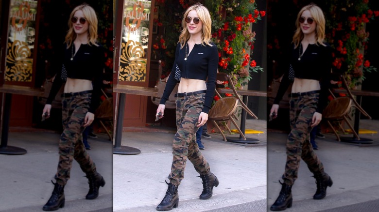 Kiernan Shipka spotted in New York City wearing a cropped long-sleeved shirt and camo pants