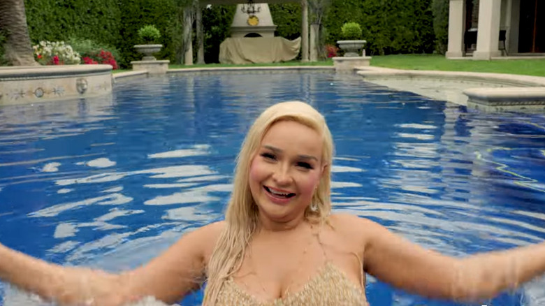 Kim Petras smiling and swimming