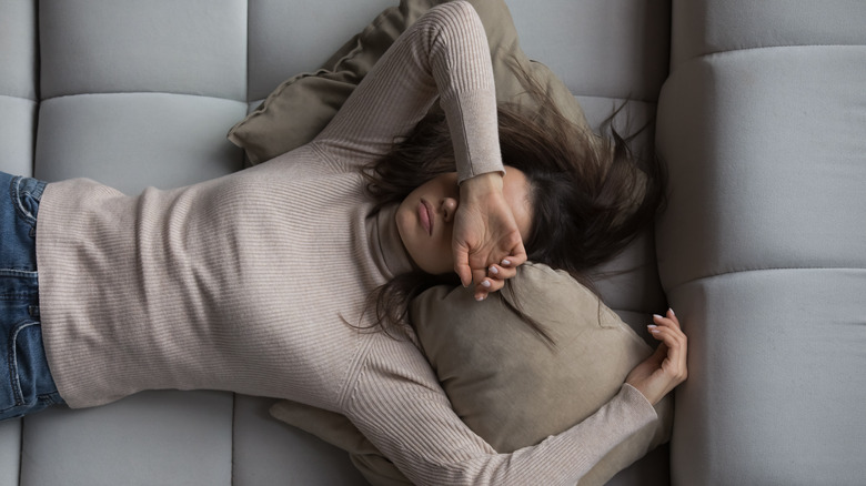 Woman exhausted on couch