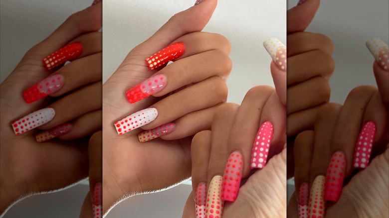 Two closed hands showing a dotted nail design