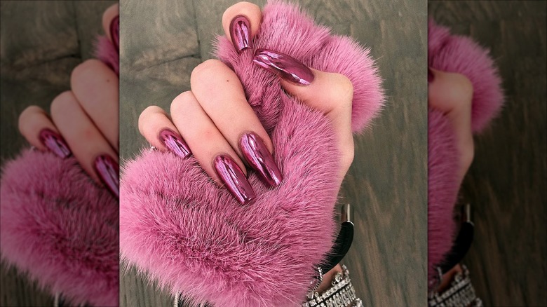 Pink chrome nails against pink faux fur