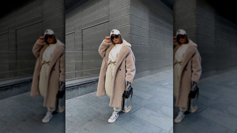 Woman in shearling coat and sweats