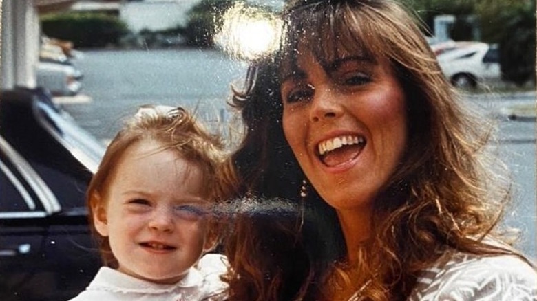 Dina Lohan holding a young Lindsay Lohan