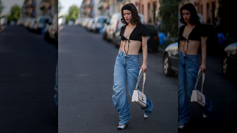 Woman in a crop top and denim 