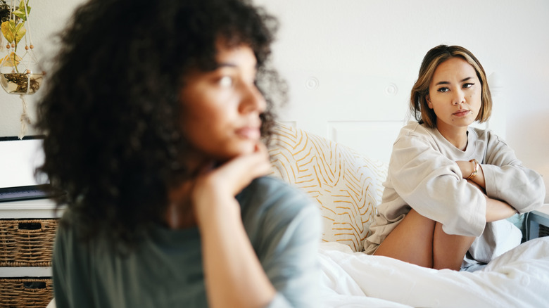 two women in bed fighting