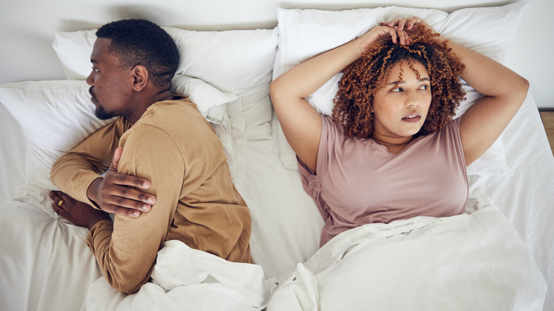 woman and man angry in bed