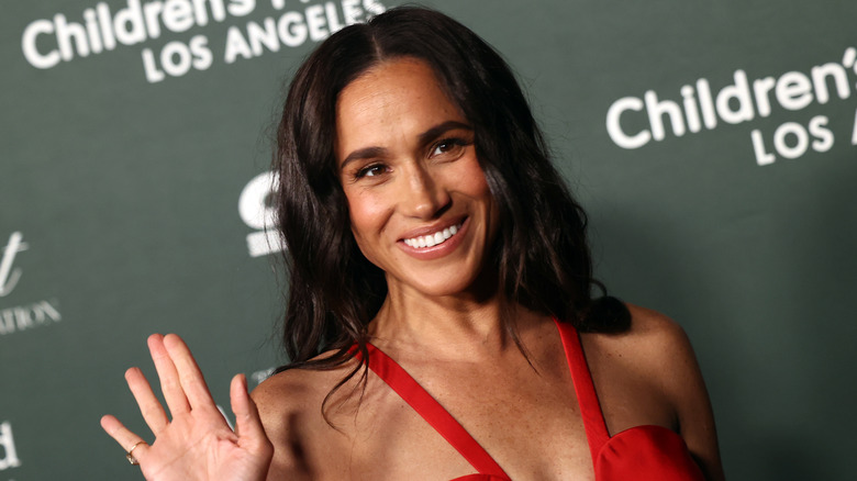 Meghan Markle at an event in a red dress