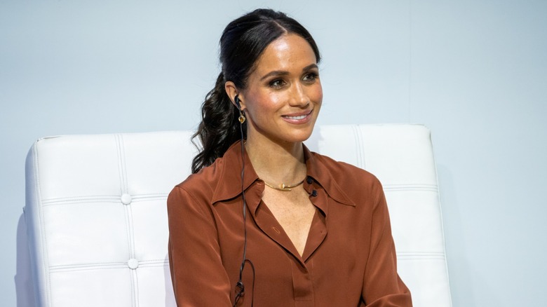 Meghan Markle sitting smiling