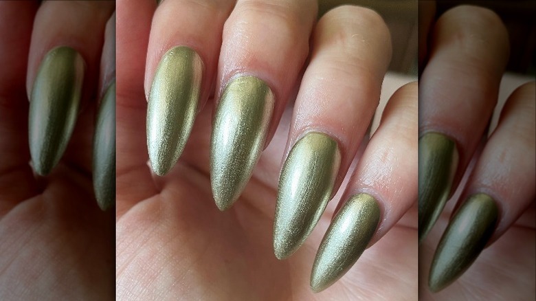 fingers with gold nail polish