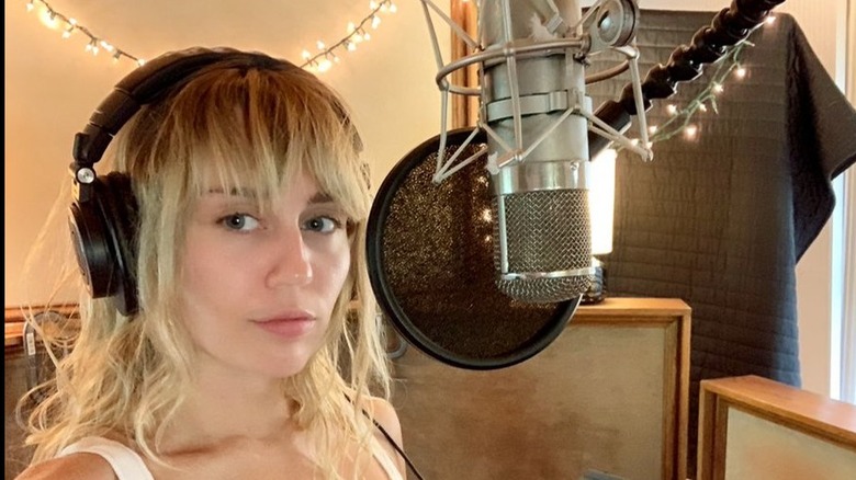 Miley Cyrus taking a selfie in the recording studio