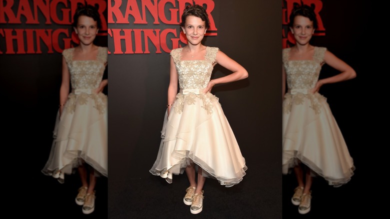 Millie Bobby Brown posing with a hand on her hip at the 2016 "Stranger Things" premiere