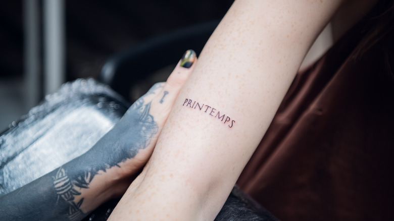 Person showing off minimalist tattoo