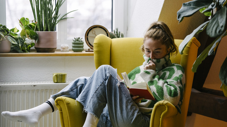 Woman reading book in chair