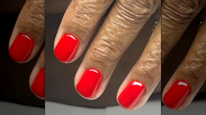 Person with a red manicure