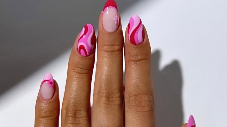 A short manicure with pink and red designs