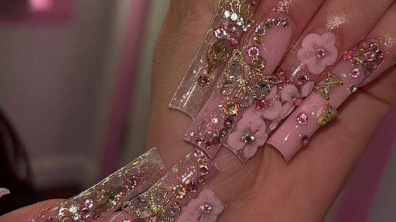 Long nails with large butterflies, flowers, pearls and crystal embellishments