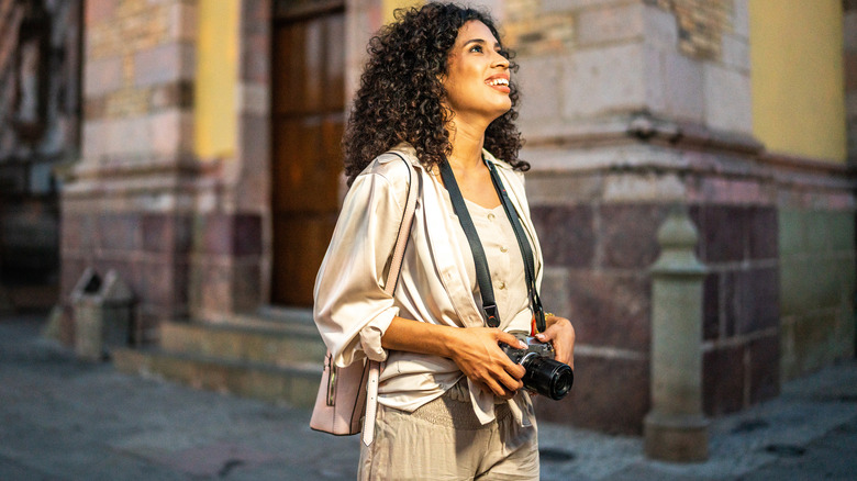 Woman exploring city with camera