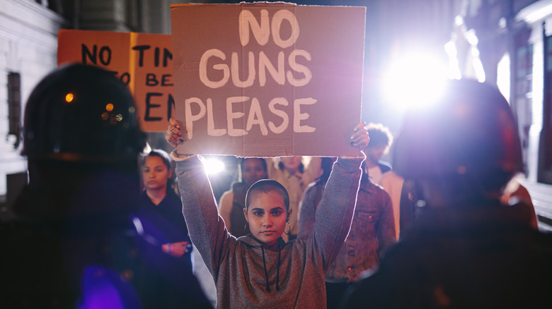 A woman holding a sign at an anti-gun rally 