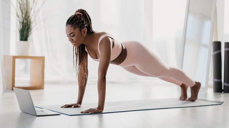 woman planking on yoga mat