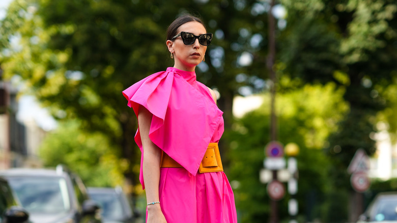 Woman neon pink dress outdoors sunglasses
