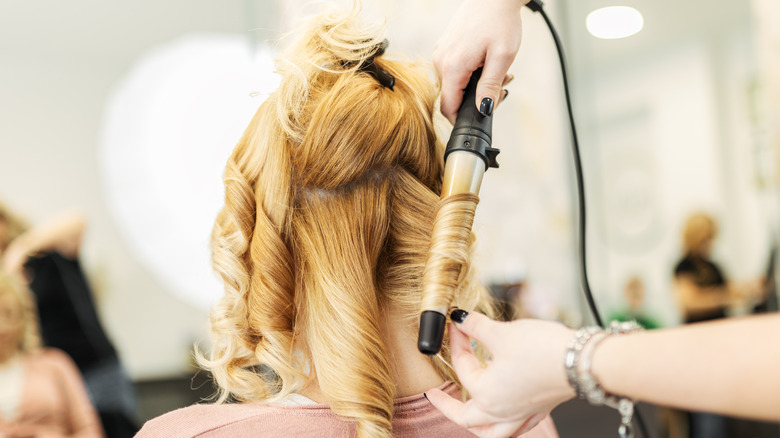 Woman having her hair curled
