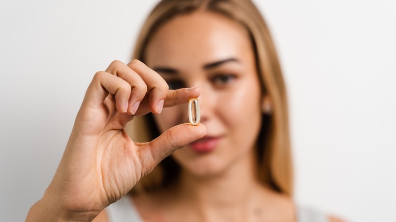 Woman holding a pill