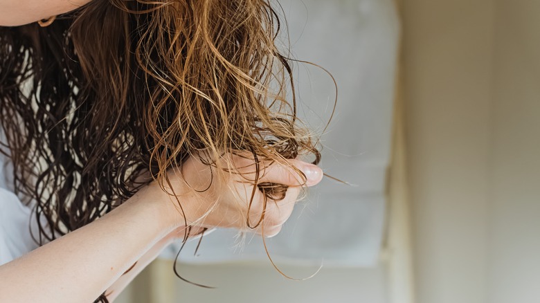 Woman wetting hair