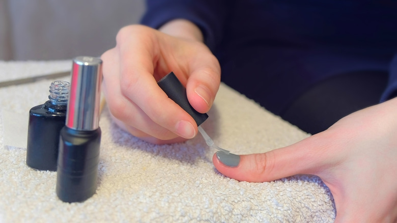 Woman applying nail polish 