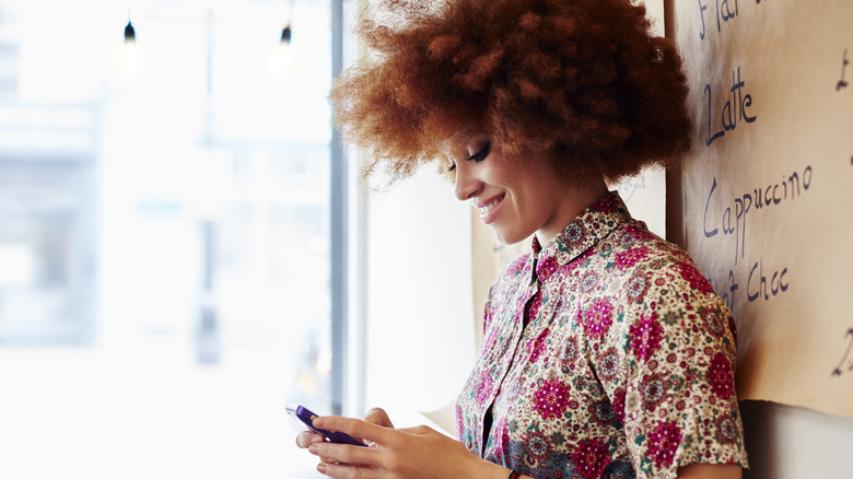 Woman smiling and texting