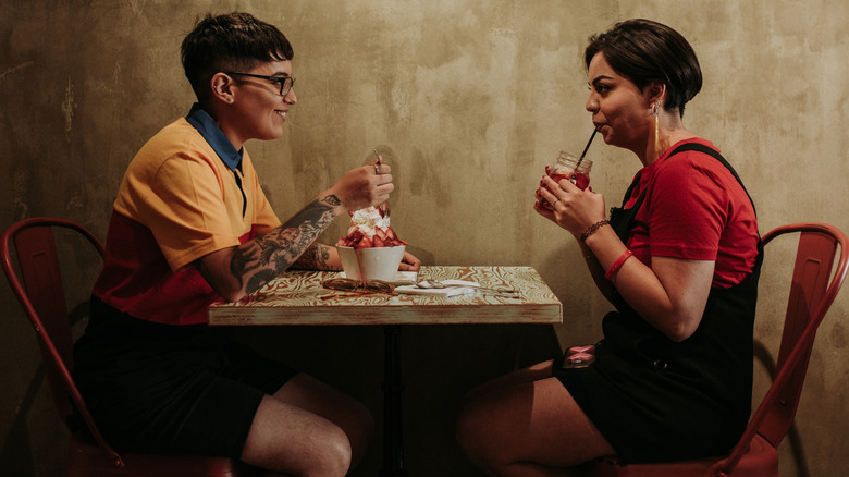 Two people sitting at a table possibly on a date