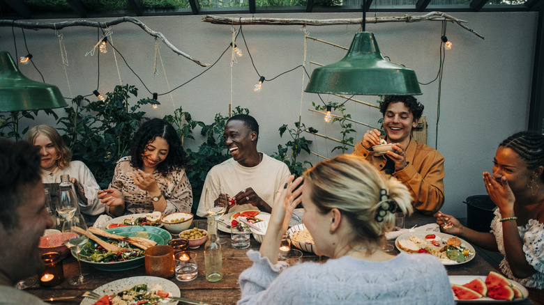 Group of friends smiling and having a meal together