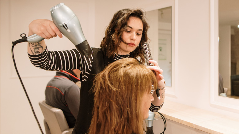 Hairdresser doing woman's hair